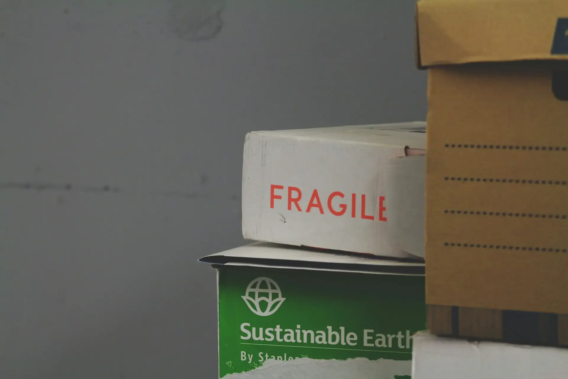 Stacked cardboard boxes, including one marked fragile