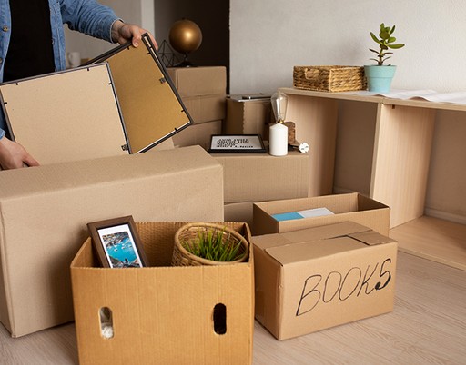Illustrative photo of framed artwork and boxes during packing